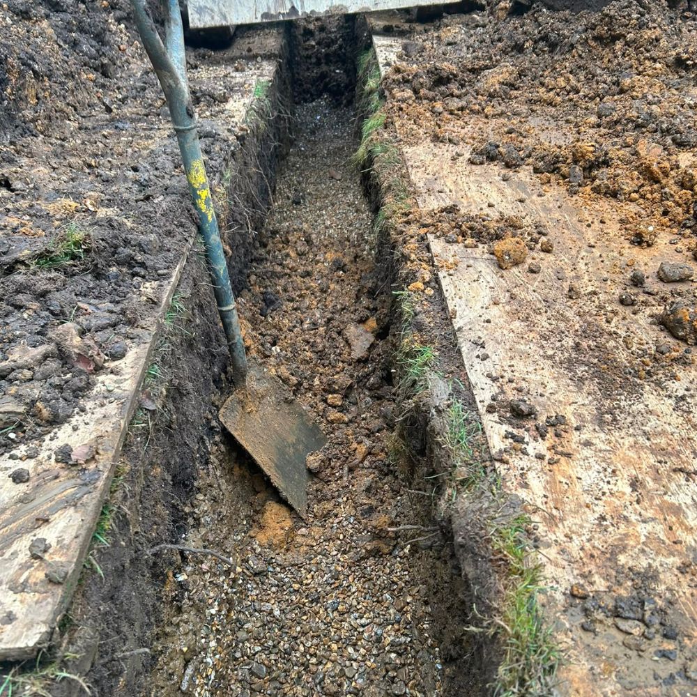 Excavated trench providing access to underground drainage pipework
