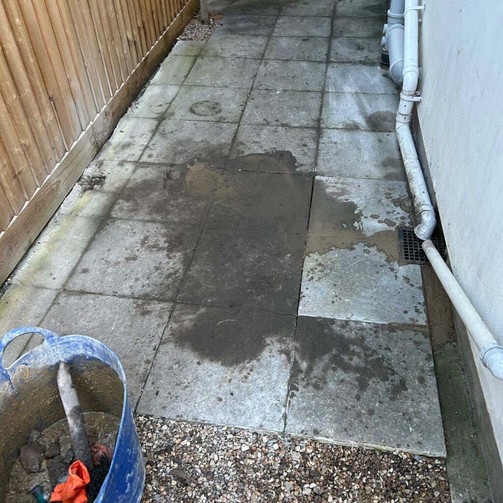 Paving reinstated around an inspection chamber beside a property.